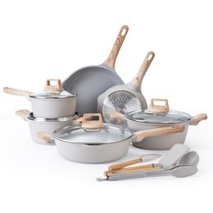 an assortment of pots and pans with wooden handles on a white background, including one for the cookware