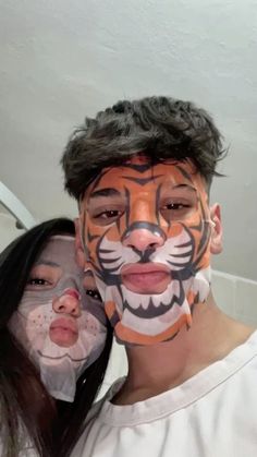 two people with their faces painted like tigers