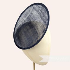 This rounded scoop fascinator hat base is made from a triple layer of french navy stiffened sinamay millinery fabric and is ideal for making an instant fascinator! The scooped center of the disc allows you to get creative by positioning it at different angles on the head.  Just add elastic, headband or comb for securing to the head (not included but available in our shop!) Measurements: Diameter: 21cm (8.2 inches) Height: 2cm (0.7 inches)  Available in several colours from our millinery supply s Sinamay Fabric, Sinamay Fascinator, Blank Hats, Millinery Supplies, Hat Base, Velvet Flowers, Fascinator Hat, Feather Flower, Millinery Hats