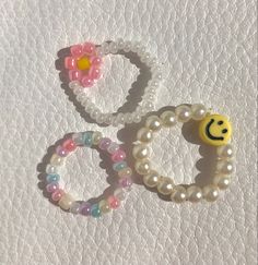 three bracelets with smiley faces on them