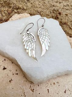 Fly free in our truly stunning white abalone shell and 925 Sterling silver earrings  Wing symbolism is diverse, but most commonly wings signify freedom, escape & protection.   Wings are the expression of the aspiration of the soul towards a higher than human condition.   Whether you're honouring yourself with a walk through nature or out to dinner with someone special these stunning adornments will inspire you fly high!  Light & comfortable to wear, you will never want  to take these earrings of White Wing-shaped Earrings For Gift, Earrings Wing, Fly Free, Silver Wings, Fly High, Wing Earrings, Human Condition, Wedding Jewelry Earrings, Shell Earrings