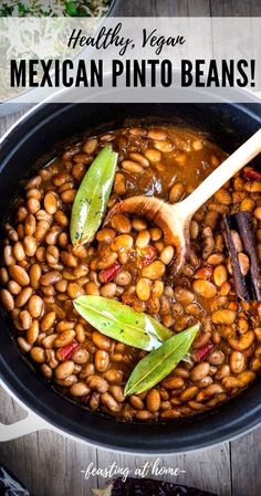 mexican pinto beans in a skillet with a wooden spoon on the side and text overlay that reads healthy vegan mexican pinto beans