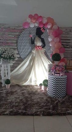 a decorated room with balloons and decorations on the wall, including a bride's dress