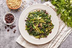 a white plate topped with broccoli and raisins on top of a table