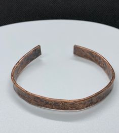 Boho Rustic Hammered Solid Copper Cuff Bracelet. Approximately 5/16" wide and 6 1/4" long. Adjustable to the wrist. This bracelet has been antiqued, polished and sealed. Sealed with Protectaclear. ProtectaClear is a clear, protective coating that is tough enough to protect jewelry and is safe for wear against skin. ProtectaClear is practically invisible once applied and will seal and protect jewelry from tarnish, oxidation, and corrosion. Classic Adjustable Etched Bangle, Adjustable Patina Bangle As Gift, Adjustable Etched Bronze Bracelets, Classic Adjustable Stamped Cuff Bracelet, Antique Finish Adjustable Cuff Bracelet, Adjustable Hand Forged Cuff Bracelet, Adjustable Bronze Cuff Bracelet With Antique Finish, Adjustable Etched Bronze Cuff Bracelet, Classic Stamped Adjustable Cuff Bracelet