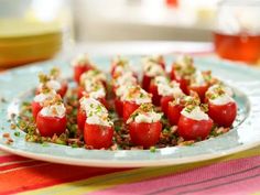 small appetizers are arranged on a plate with condiments in the middle