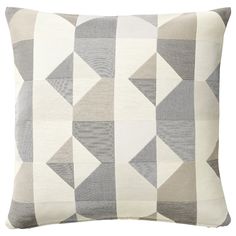 a gray and white pillow with geometric shapes