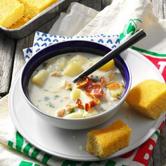 a bowl of soup and two pieces of bread on a plate