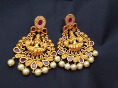 Traditional matte gold finish lightweight Lakshmi stud earrings which are studded with semiprecious stones. Stones and polish are guaranteed. Pearls are hand settled carefully. Length - 2 1/4 inches Width - 1 1/2 inches Weight of one earring - 17 grams AWG -21 Gift box packing with extra push backs for earrings. Jewelry care instructions : 1. Keep jewelry away from direct heat,water,perfumes,deodorants and other strong chemicals. 2. Any moisture or sweat should be properly wiped off before prese Lakshmi Earrings, Ruby Stud Earrings, Ruby Earrings Studs, Earrings Emerald, Temple Jewelry, Dance Gifts, South Indian Jewellery, Jewelry Care Instructions, Box Packing