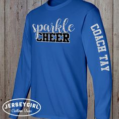 "Stay warm AND still sparkle with our custom glitter cheerleading long-sleeve cheer shirt! Personalize your own long-sleeve cheerleading shirt with your cheer team name (or your own custom text) on the front, and your cheerleader's name on the left sleeve. Perfect for custom cheer warm-ups for a glitter cheer mom competition shirt! Unless you live in Georgia. It's December and it's like 74 degrees. We legit have the air conditioning on right now. Enter your personalization under \"Add your perso Cheap Cheerleading Tops With Team Logo, Cheap Long Sleeve Tops For Team Spirit, Cheap Cheerleading T-shirt With Team Name, Cheap T-shirt For Cheerleading With Team Name, Cheap Cheerleading Top With Team Name, Cheap Short Sleeve Cheerleading Tops, Cheap Short Sleeve Tops For Cheerleading, Cheer Warm Ups, Cheer Sweater