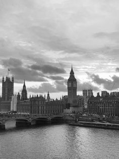 black and white photograph of the big ben clock tower towering over the city of london