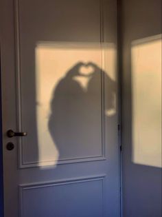 the shadow of a person standing in front of a door