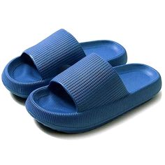 a pair of blue slippers sitting on top of a white floor