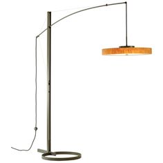 a floor lamp with a wooden shade on the top and an oval light fixture below it