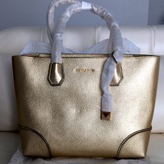 Michael Michael Kors Studio Mercer Metallic Tote Nwt 100% Authentic Guaranteed! Color: Pale Gold Leather Metal Hardware Zip Closure Approx. 14.5" W X 10" H X 5.5" D Strap Drop 22-23" Handle Drop 6.5" Interior Features: One Back Slip Pocket One Back Zip Pocket Exterior Features: One Top Back Zip Pocket Double Handles/Single Strap 30s8mz5t2m New With Tags Attached Retail $278.00 Dust Bag Included Godbless Gold Bags With Branded Hardware And Double Handle, Classic Gold Shopping Bag, Everyday Gold Bag With Branded Hardware, Gold Bag With Branded Hardware For Everyday, Gold Everyday Bag With Branded Hardware, Luxury Gold Shoulder Bag For Errands, Gold Bag With Top Carry Handle For Errands, Gold Leather Bags For Errands, Leather Gold Bag For Errands