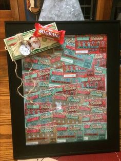 a framed photo with candy bar wrappers on it and a bow hanging from the top