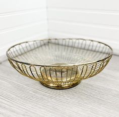 a metal bowl sitting on top of a wooden table