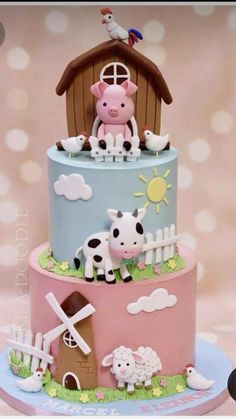 a three tiered cake decorated with farm animals