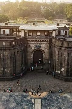 an aerial view of people walking in front of a large building