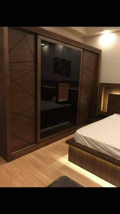 a large bed sitting next to a closet in a bedroom