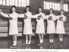 four women holding tennis rackets in their hands