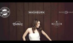 a woman standing in front of a wall with the words washburn on it's side