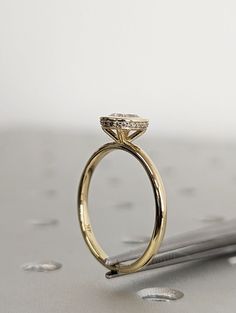 a close up of a gold ring with a diamond on the top and bottom part