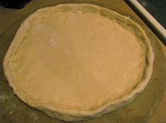 an uncooked pie crust on a wooden table