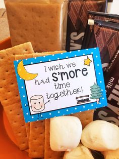 some crackers and marshmallows on a plate with a sign that says i wish we had s'more time together