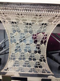 an intricately designed chair sitting on top of a table