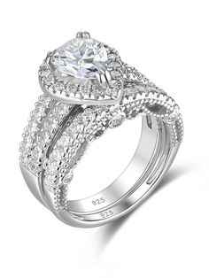 a white gold ring with two rows of diamonds on the band and a center diamond in the middle