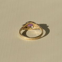 Inspired by ancient rings that graced the hands of Roman Empresses, this is a piece to be treasured for decades and passed down through the centuries. A detailed braided solid gold band encircles your finger, displaying a substantial cabochon amethyst in a handcrafted bezel setting. This setting is the same used by ancient goldsmiths from the earliest known periods of history. The Romans believed amethyst carried within it temperance and grace, a talisman to ward off drunkenness and the regrets Ancient Rings, Heirloom Ring, Heirloom Rings, Amethyst Set, Solid Gold Band, Free Gems, Ethical Jewelry, Gold Piece, Recycled Gold