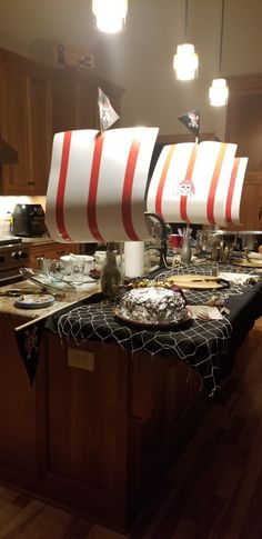 a kitchen island with a boat on top of it and other items sitting on the counter