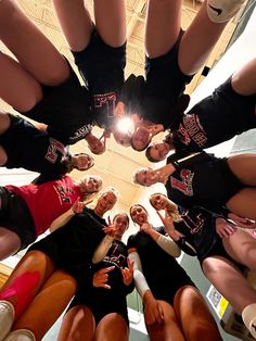 a group of women standing in a circle with their hands together