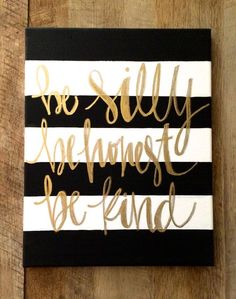 a black and white striped canvas with gold foil lettering that says, we still are almost friends