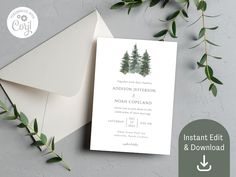 the wedding card is next to an envelope with greenery