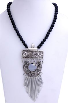 Black Beads and a longer three level graceful pendant with a reflective gemstone-like center core defines this modern look tribal necklace. The length is 28 inches, with no hooks (i.e one size), and the pendants have an overall 5.5 inches drop. Bohemian Metal Beaded Necklace With Black Beads, Bohemian Silver Beaded Necklace With Black Beads, Bohemian Silver Necklace With Black Beads, Silver Long Beaded Necklace With Black Beads, Silver Long Necklace With Black Beads, Bohemian Black Beaded Metal Necklace, Metal Necklaces With Black Beads For Festival, Festival Metal Necklace With Black Beads, Black Pendant Jewelry With Large Beads