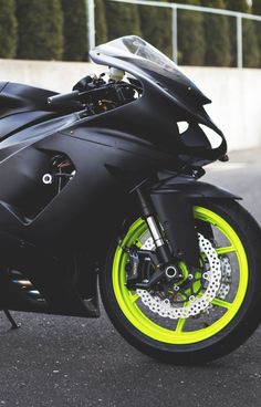 a black and yellow motorcycle parked on the street