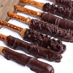 chocolate covered pretzels are lined up on a white plate