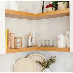 a kitchen shelf filled with dishes and cups