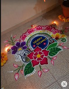 a decorated floor with lit candles and flowers on it for diwaling the festival