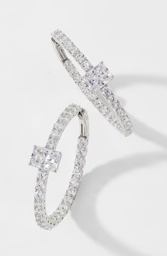 A sparkling pink cubic zirconia centers these hand-polished hoop earrings additionally adorned with smaller stones and plated in 18-karat gold. 1" hoop diameter; 1/4" width 18k-gold plate or rhodium plate/cubic zirconia Imported Sparkling Hoop Jewelry For Wedding, Cubic Zirconia Bangle With Prong Setting, Dazzling Cubic Zirconia Hoop Earrings For Wedding, Crystal Hoop Jewelry For Weddings, Silver Hoop Jewelry With Hand Set Details, Dazzling Hoop Jewelry For Wedding, Formal Brilliant Cut Cubic Zirconia Hoop Earrings, Wedding Hoop Earrings With Diamond Accents And Cubic Zirconia, White Gold Hoop Jewelry With Sparkling Stones