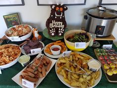 a table topped with lots of food and desserts