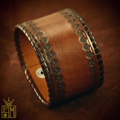 "This warm brown leather cuff is hand dyed a brown tonal finish . It is whipstitched with kangaroo lace along the edges and stamped with a beautiful custom western border. 2 hand domed and soldered Buffalo nickel snaps provide closure! the cuff is fully lined in beautiful light tan calf leather. I'll need your wrist size for this cuff! Please use the instructions in the pics above! - 2\" wide - Sunburst finish - Top craftsmanship Thanks for checking out my work! I use a fine hand in my work brid Black Leather Cuff Bracelet, Guitar Straps, Handmade Jewelry Bracelets, Buffalo Nickel, Leather Cuff Bracelet, Leather Wristbands, Cuff Watch, Leather Bracelets, Leather Cuffs Bracelet