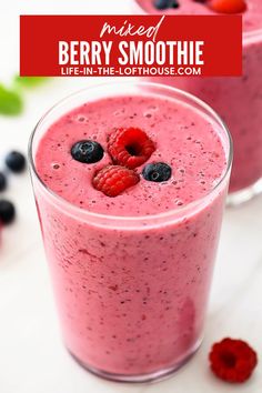 berry smoothie in a glass with berries and raspberries