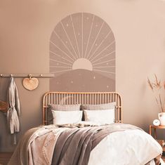 a bed sitting in a bedroom next to a wall with a sun design on it