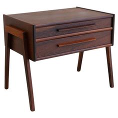 a wooden desk with two drawers on one side and an open drawer on the other