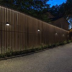 a wooden fence with lights on it at night