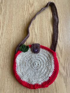 a crocheted purse sitting on top of a wooden table