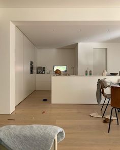 an open kitchen and dining room with white walls